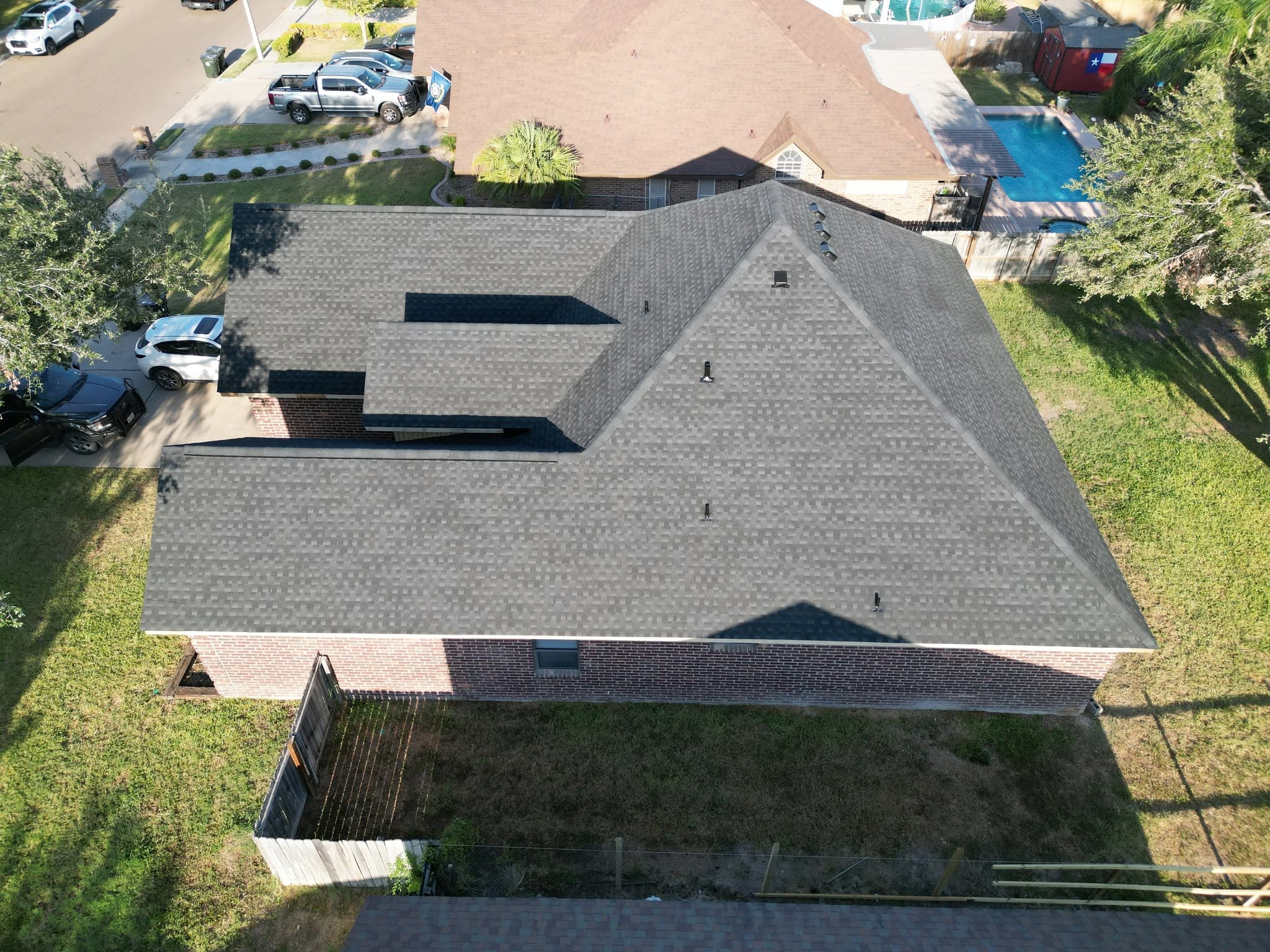 Completed Charcoal shingle roof on a brick home in Mission, Texas